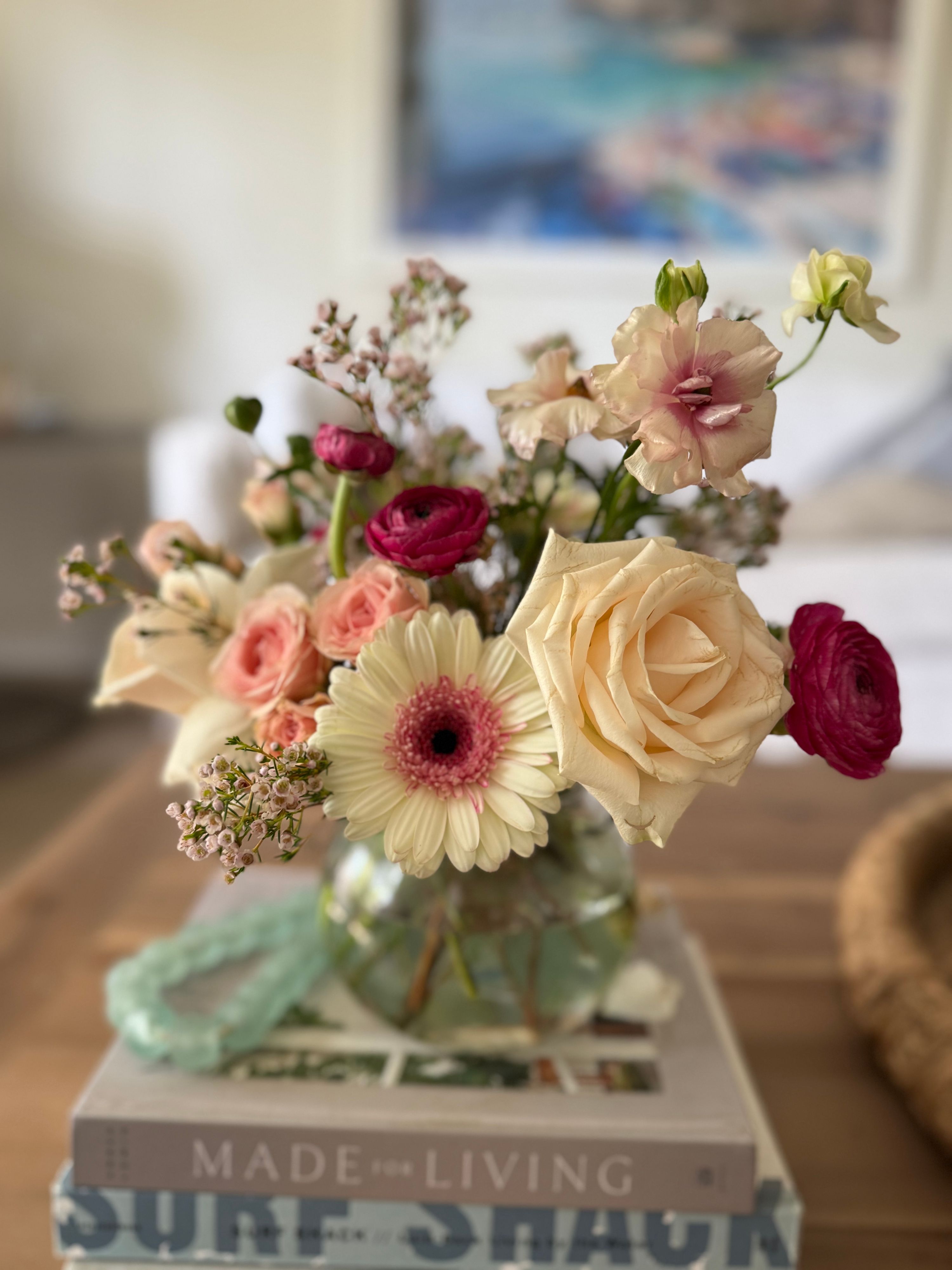 Blush and ivory arrangement with garden roses, ranunculus and a cream gerbera daisy